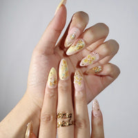 Thumbnail for Hand with decorative floral nail art on a plain background